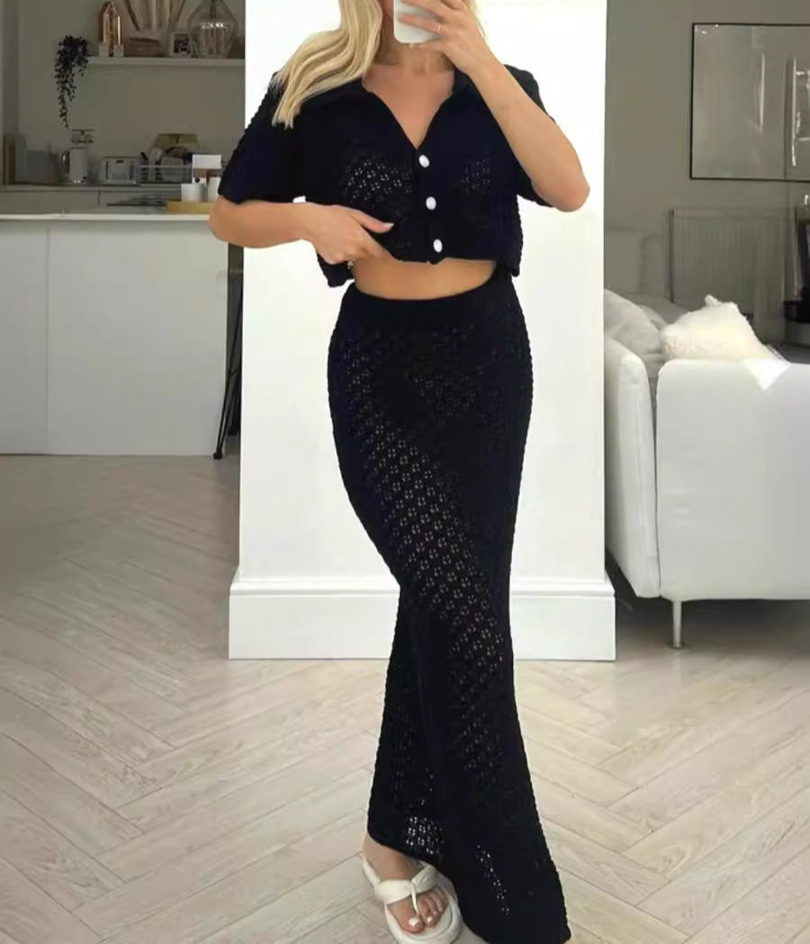 Woman taking a mirror selfie wearing a black crochet outfit in a home setting.