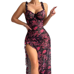 Woman wearing a black and pink floral dress with a high slit on a white background