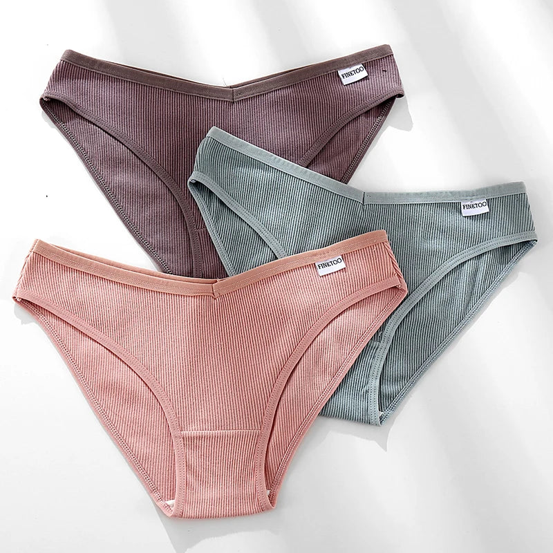 Three pairs of ribbed underwear in brown, green, and pink on a white background.