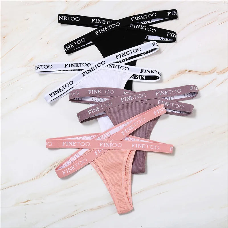 Collection of 'FINE TOO' branded headbands in various colors on a marble surface.