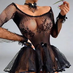 Black fishnet dress with floral details on a plain background