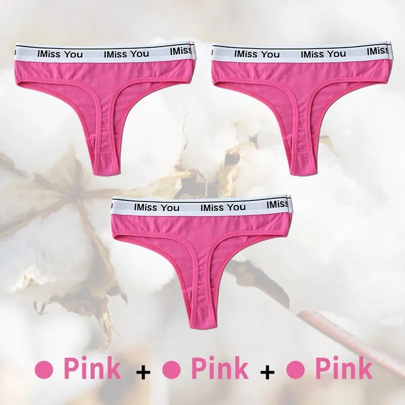 Three pairs of pink thongs with 'I Miss You' waistbands on a white background.