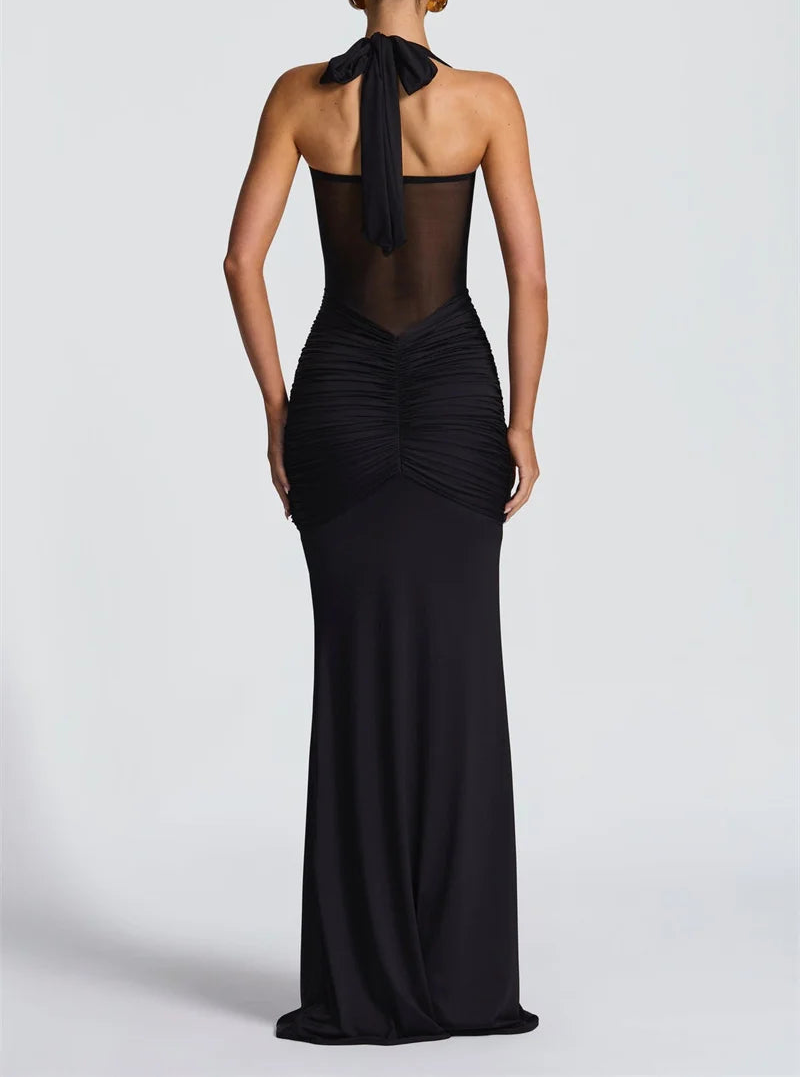 Black evening gown with sheer back on a white background