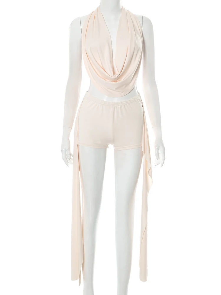Mannequin wearing a beige draped top and pants on a white background