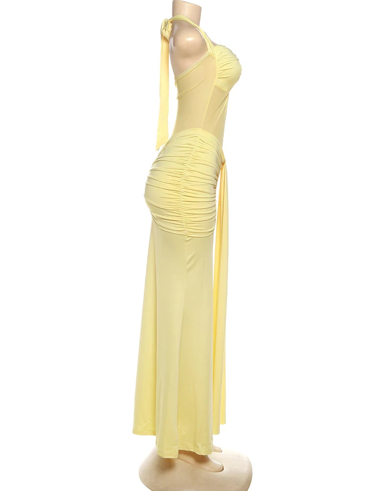 Yellow evening gown on a mannequin against a white background