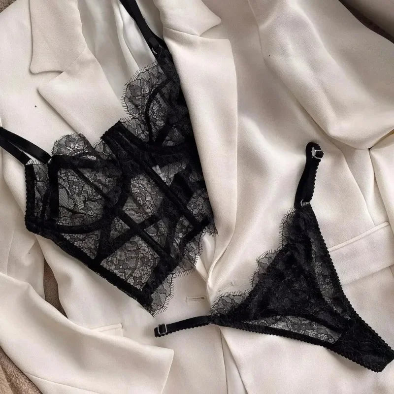 Black lace lingerie set on a white fabric background