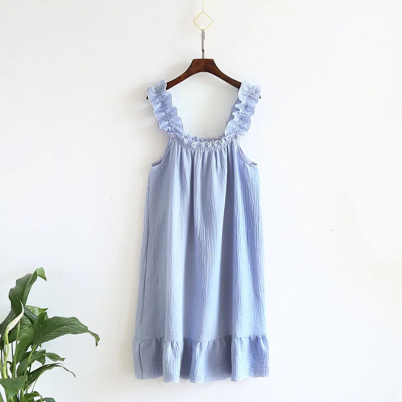 Light blue dress with ruffled straps on a hanger against a white background