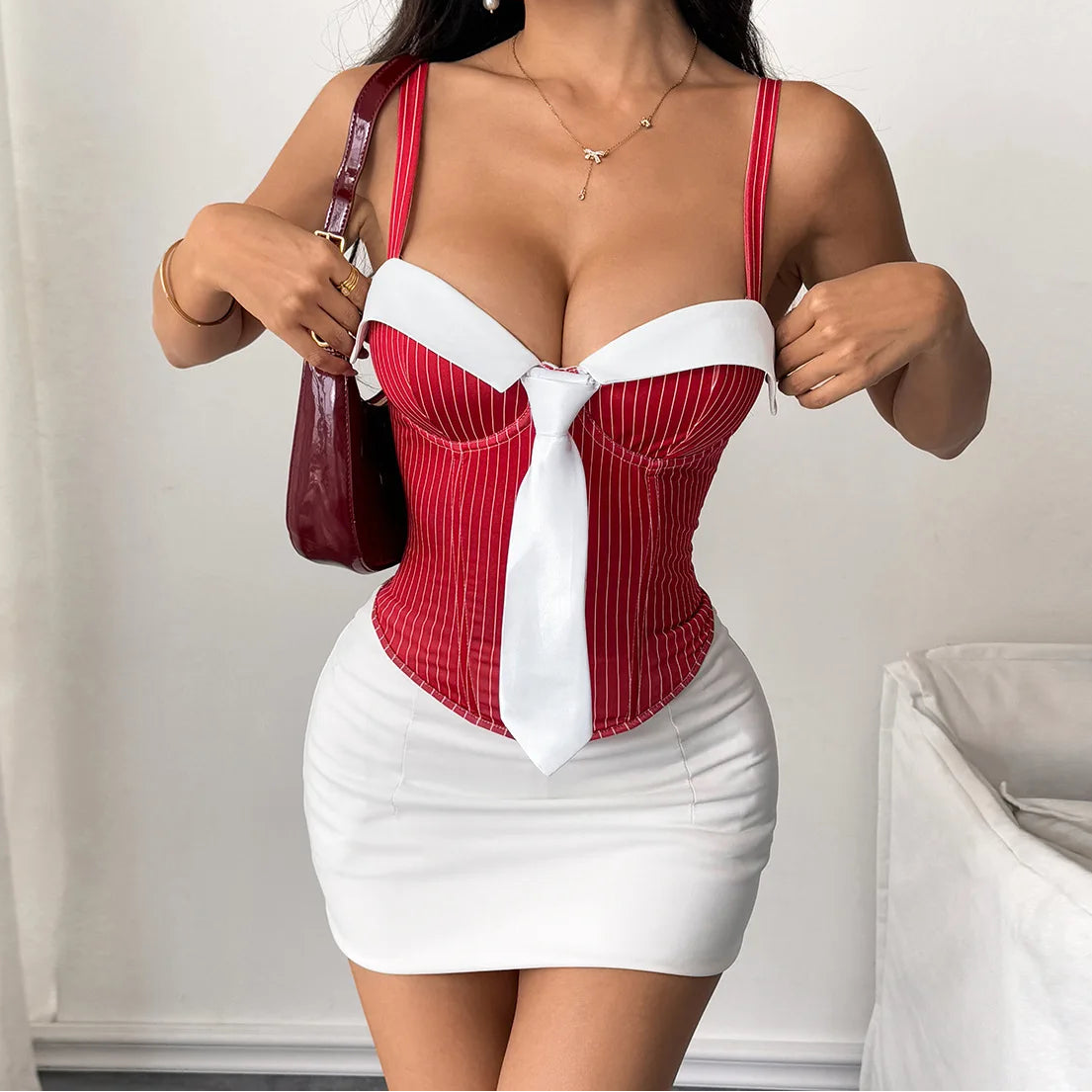 Woman wearing a red and white dress with a plain background