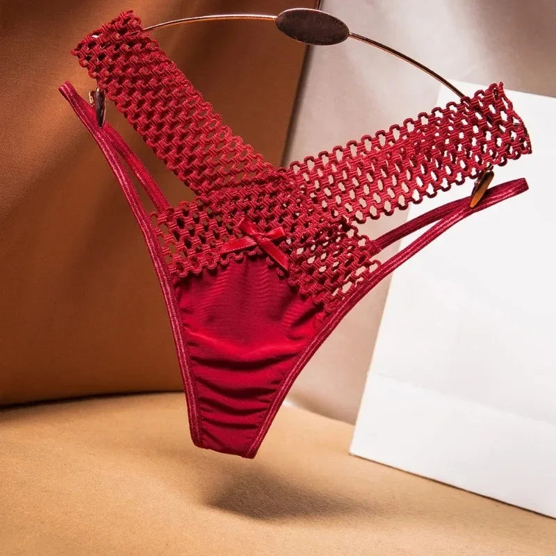 Red bikini with mesh design on a beige surface