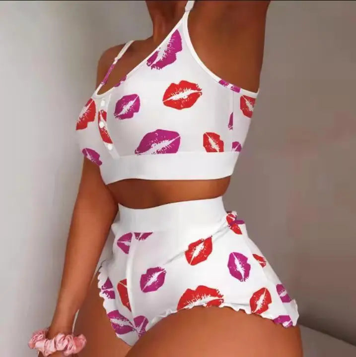 White outfit with red and pink lip print on a plain background