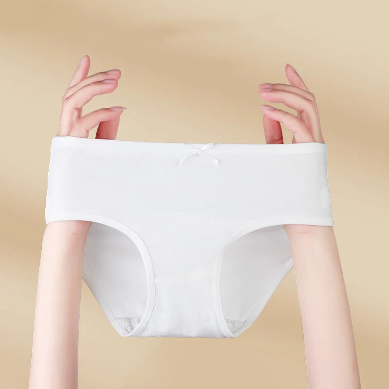 White underwear held up against a beige background