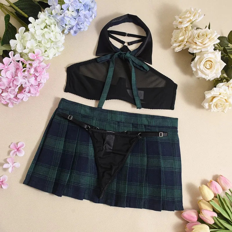 Black sheer top and plaid skirt set on a beige background with flowers.