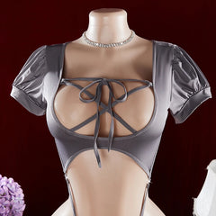 Mannequin wearing a gray strappy top with a dark background