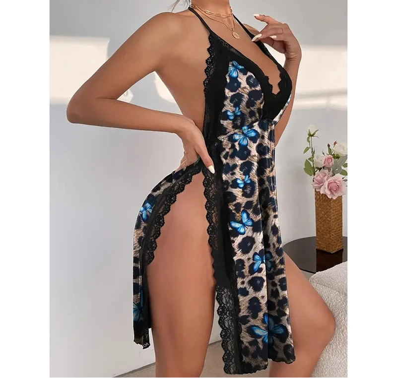 Woman wearing a black lace dress with leopard print and blue butterflies on a neutral background