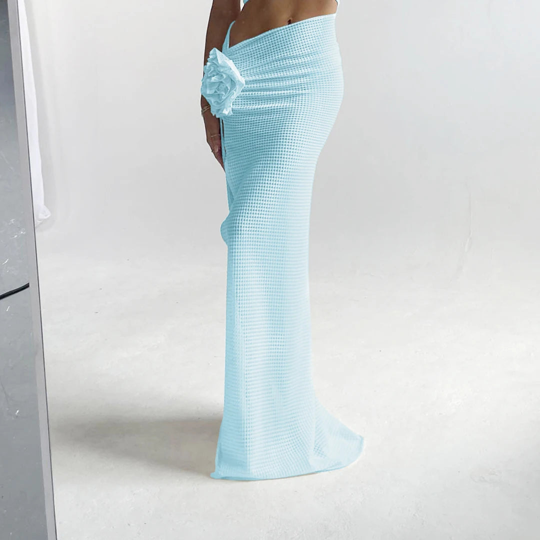 Light blue evening gown with a floral detail on a white background