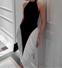 Woman wearing a black and white dress in an elegant interior setting