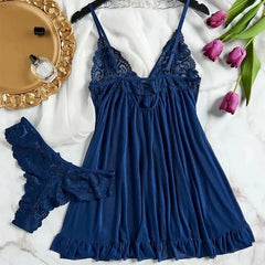 Blue lace nightgown with matching panties on a marble surface with decorative elements.