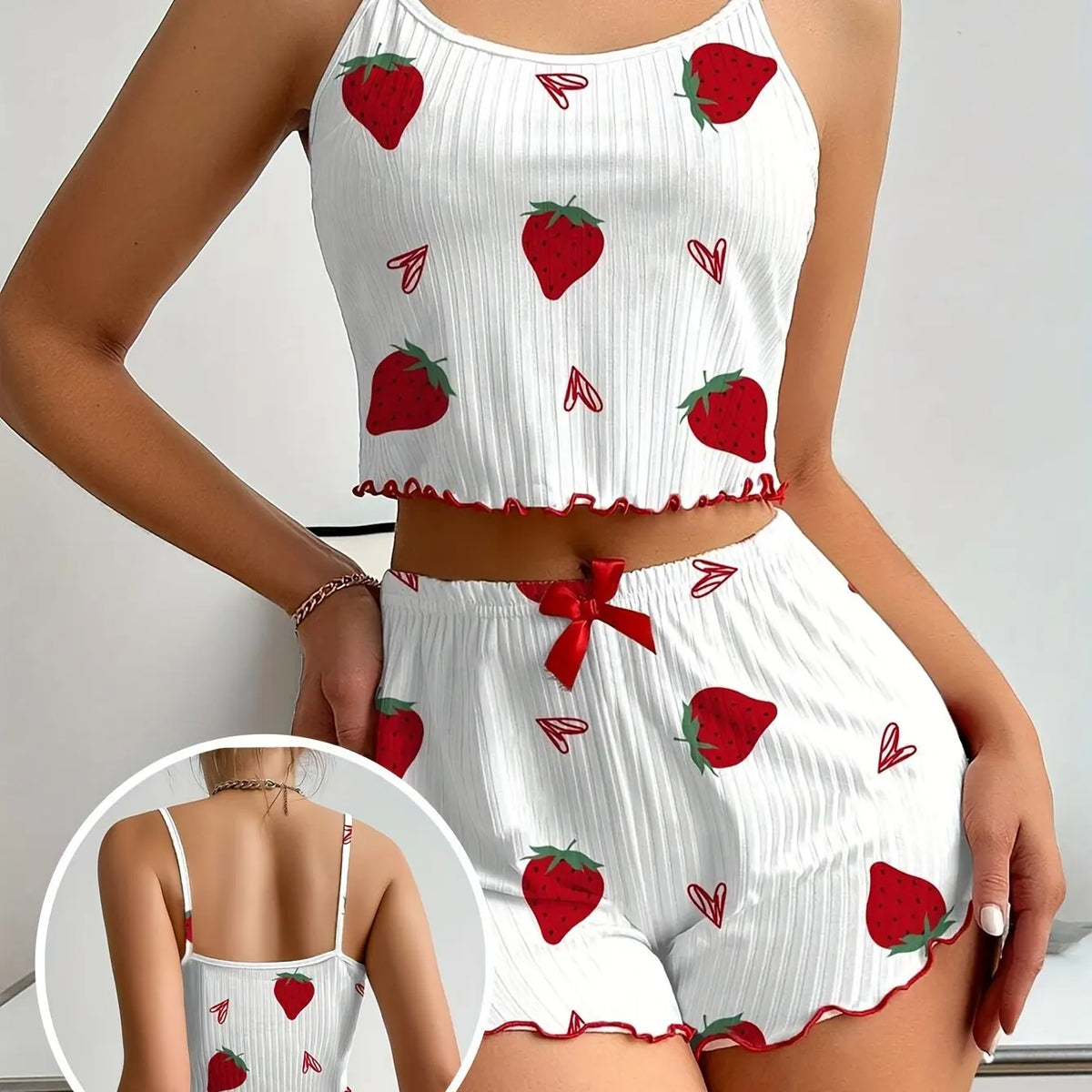 White outfit with red strawberry pattern worn by a person, with a close-up inset showing the back view.
