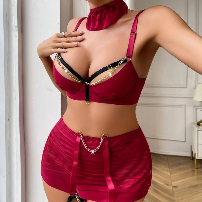 Person wearing a red lingerie set with gold accents in a room.