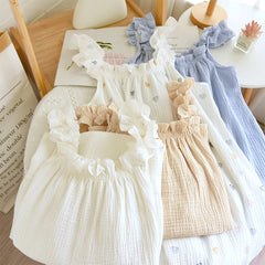 Set of baby rompers in various colors on a wooden surface.