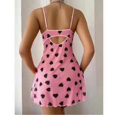 Pink dress with black heart patterns on a plain background