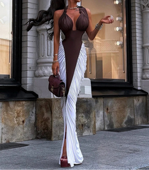 Woman in a brown and white dress standing in front of a store window.