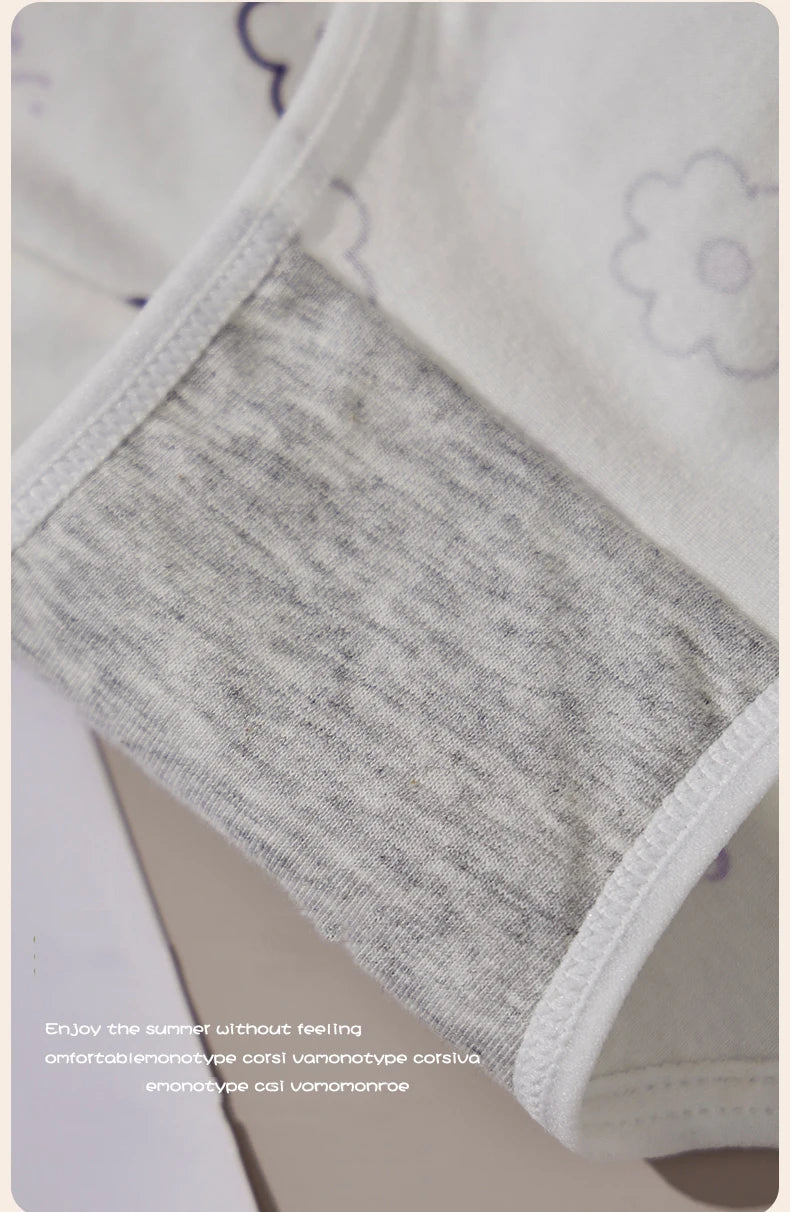 Gray baby bodysuit with white trim on a light background