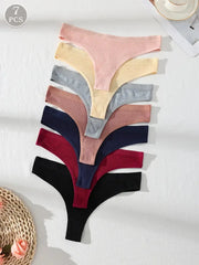 Set of seven colorful ribbed thongs on a white background