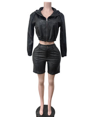 Black leather jacket and shorts set on a mannequin against a white background