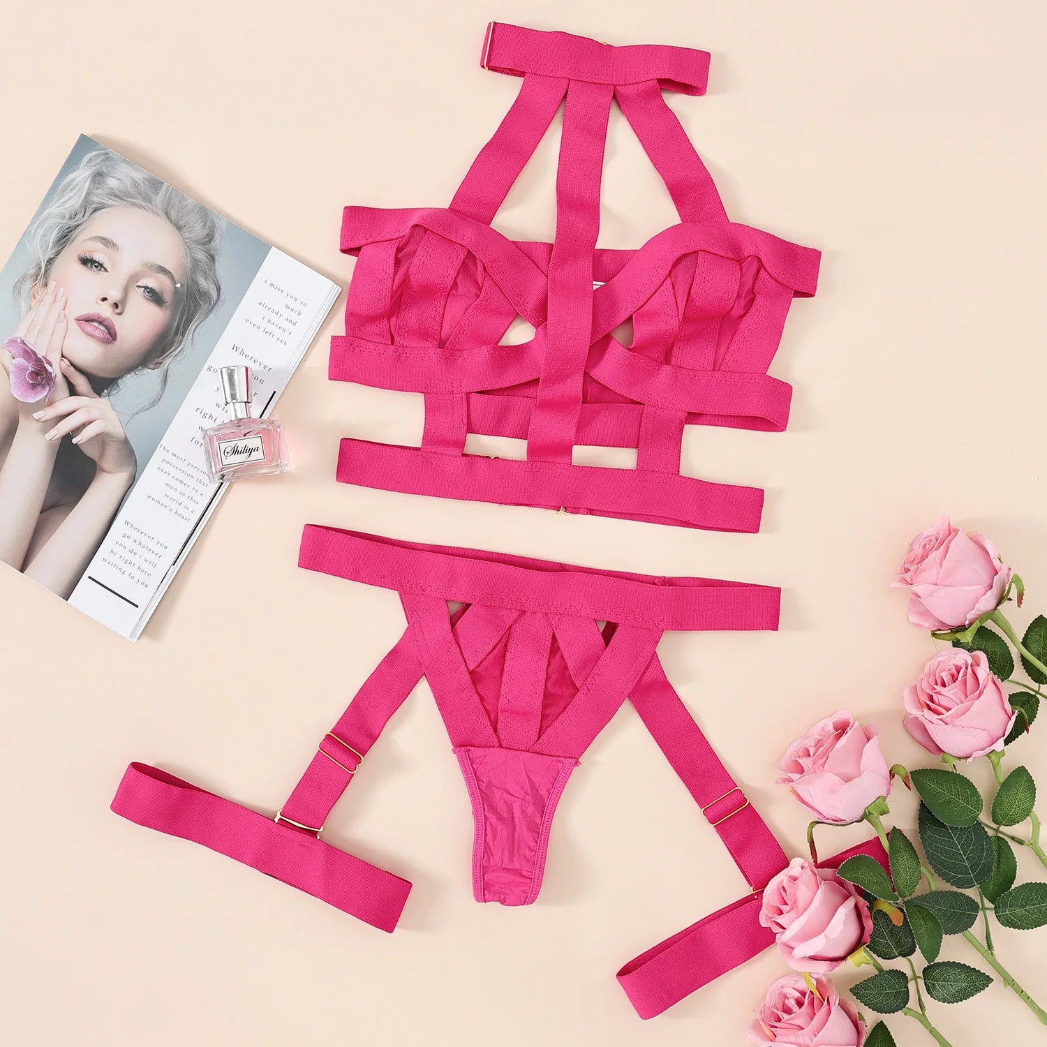 Pink lingerie set with roses and a magazine on a beige background