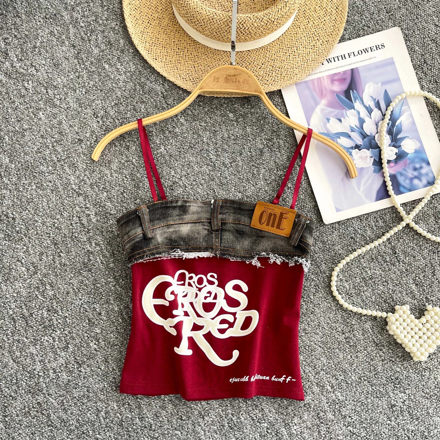 Red tank top with denim bottom and 'Casual Elegance' text on a hanger with accessories.