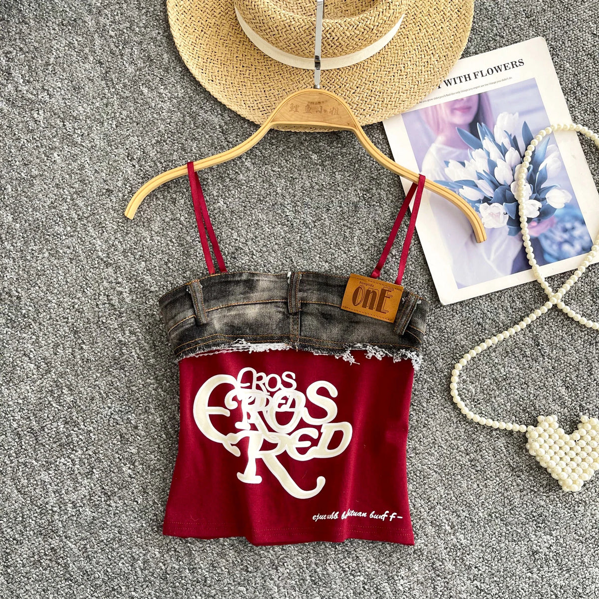 Red tank top with denim bottom and 'Casual Elegance' text on a hanger with accessories.