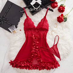 Red lace lingerie set on a white fur surface with decorative items.
