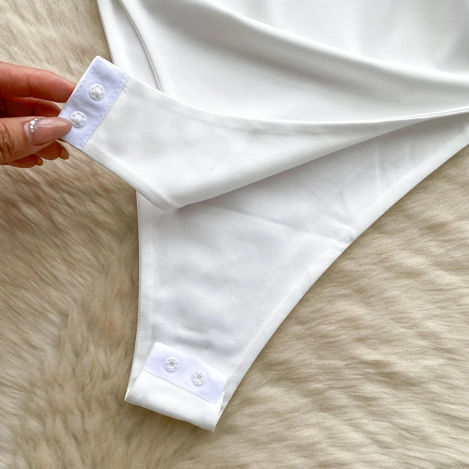 White shirt with rolled-up sleeves on a fur surface