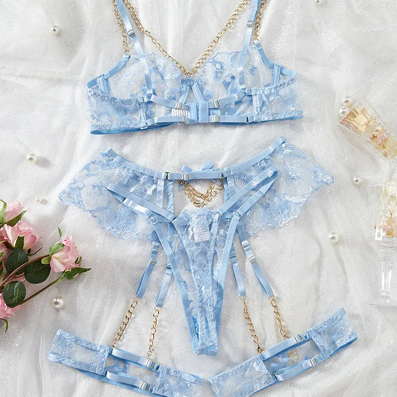 Blue lace lingerie set with chain details on a white background with flowers.