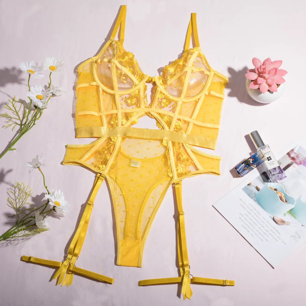 Yellow lingerie set on a stand with flowers and a magazine in the background