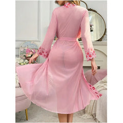 Pink dress with floral embellishments in a room setting