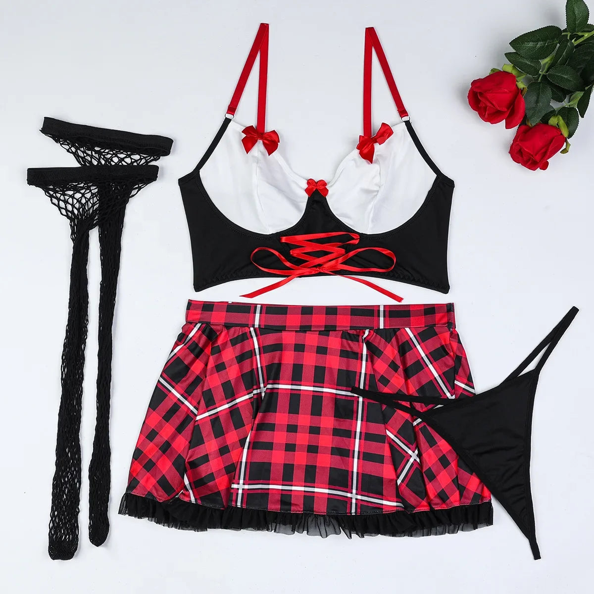 Black bra with red accents, red and black plaid skirt, black stockings, and a black net stocking on a white background.