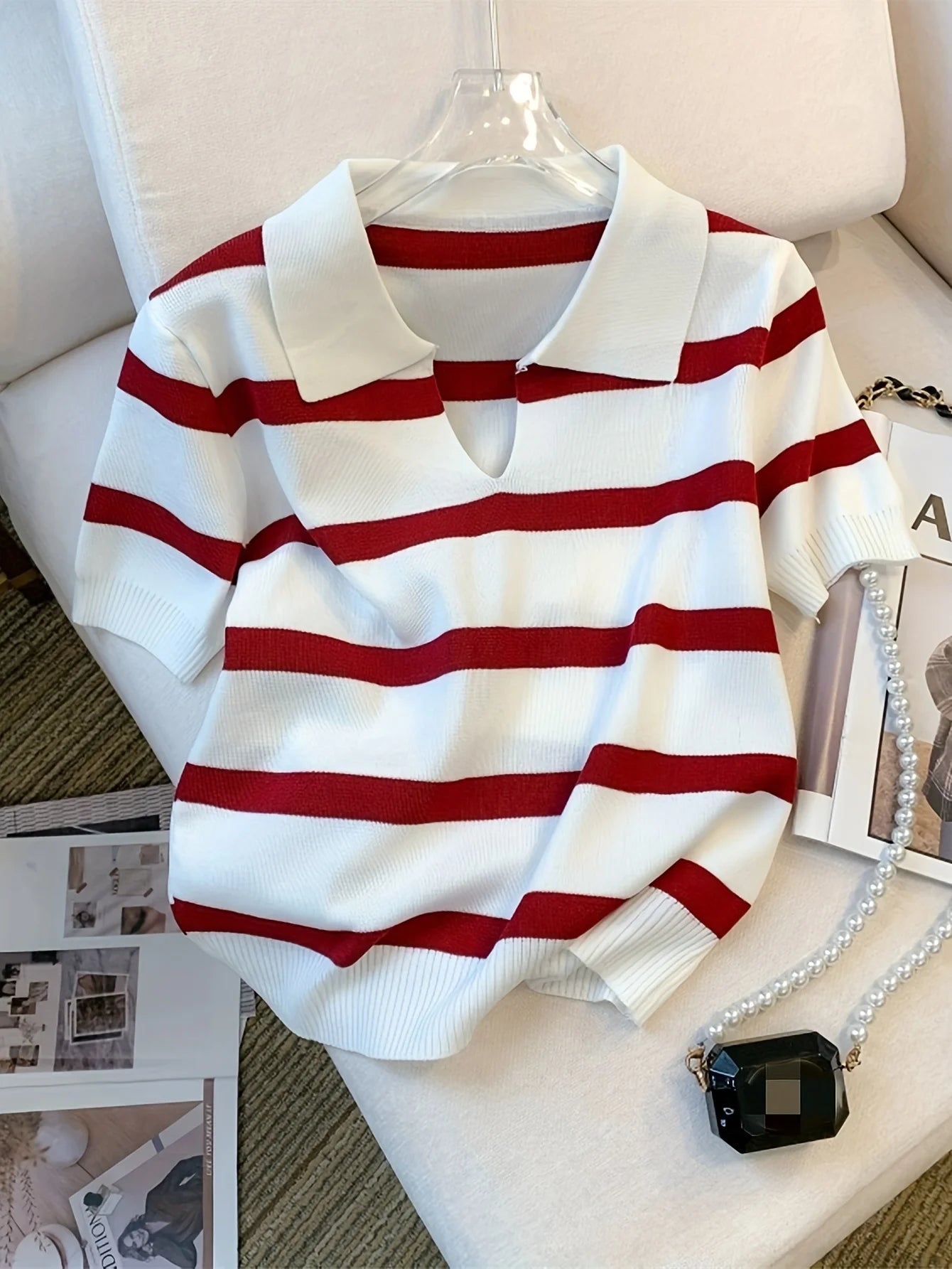 Red and white striped sweater on a mannequin with a neutral background