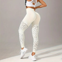 Person wearing white patterned leggings and sports bra on a neutral background