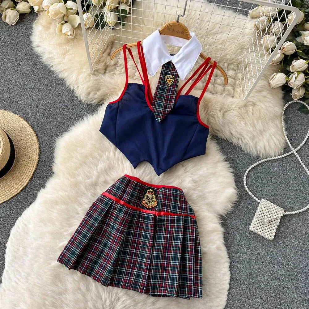 School uniform set with navy top, plaid skirt, and tie on a fluffy white rug.