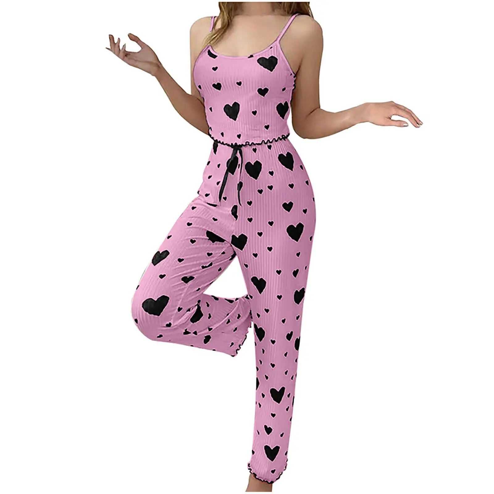 Pink romper with black heart patterns on a white background