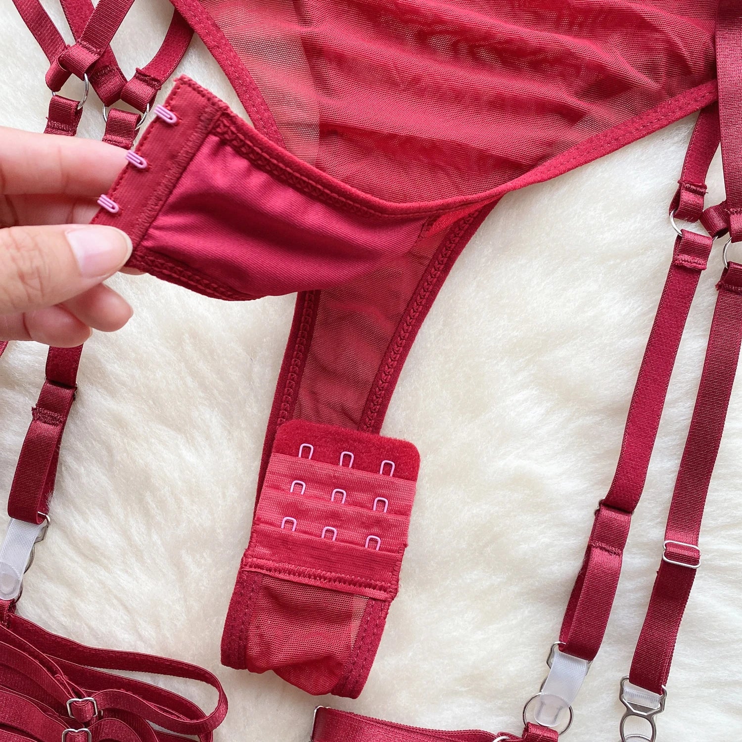 Red lingerie set with straps on a white surface