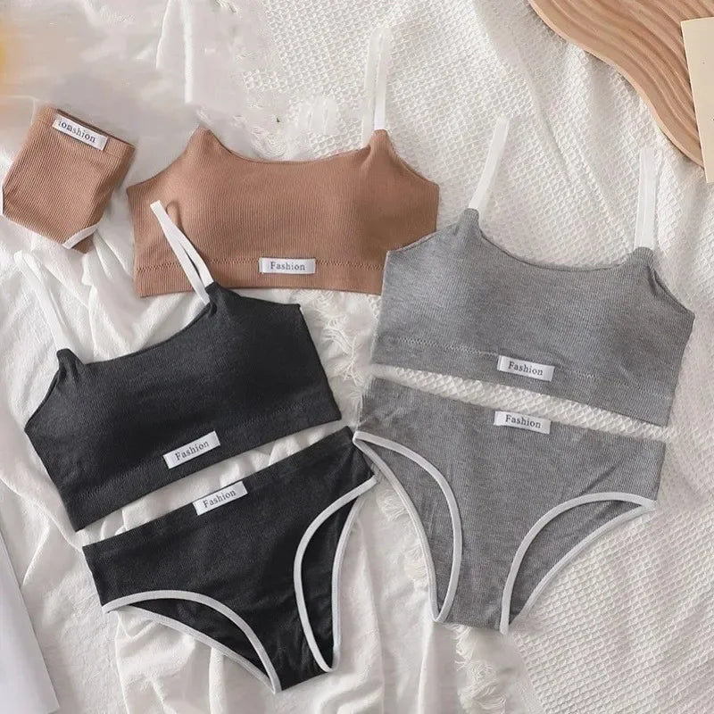 Set of black and gray women's underwear with 'Fashion' labels on a textured white surface.