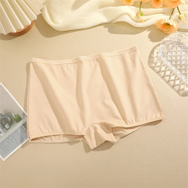 Beige underwear on a beige surface with flowers in the background