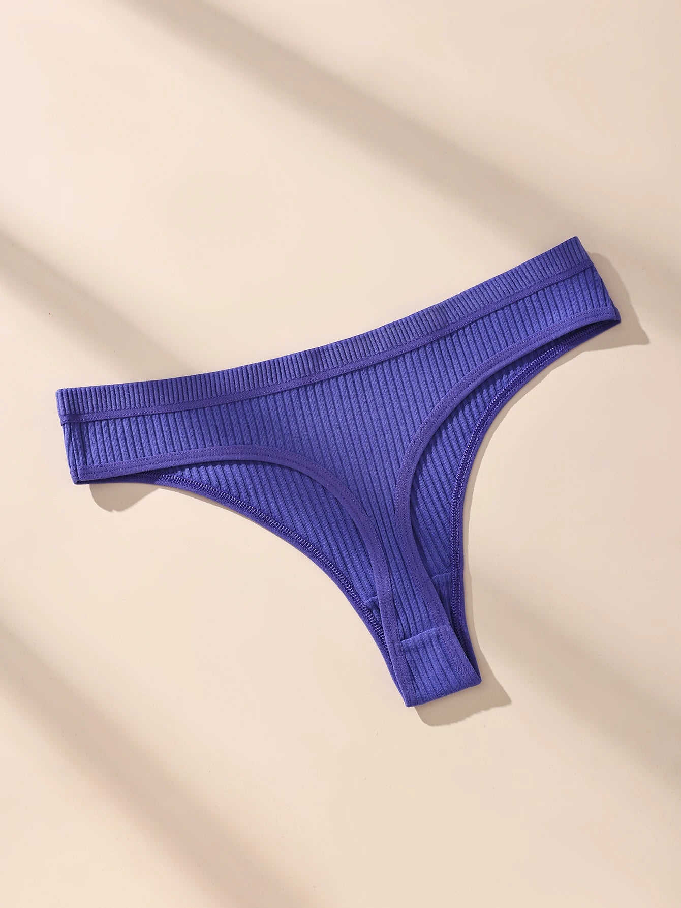 Blue ribbed thong on a beige background