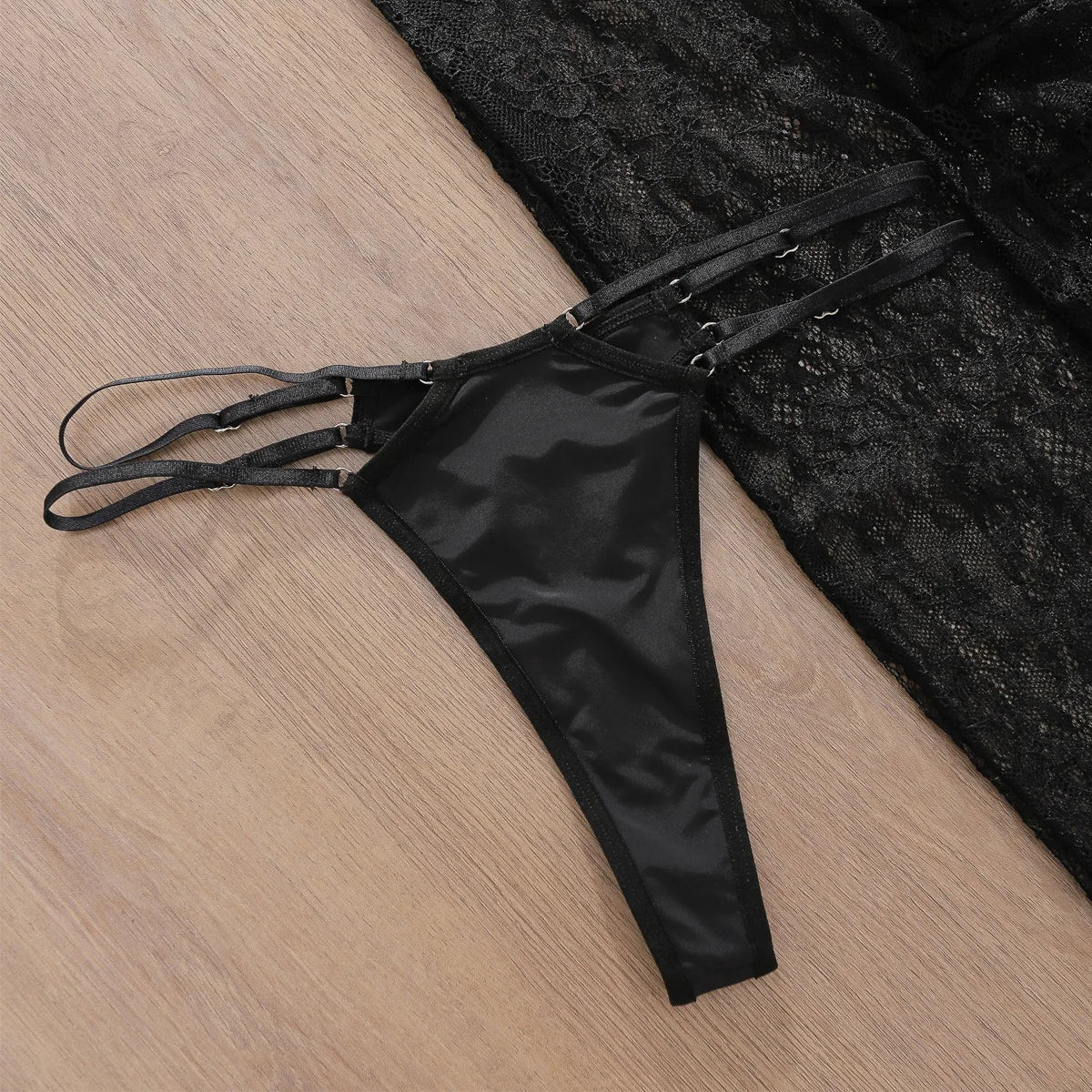 Black lace lingerie set on a wooden surface