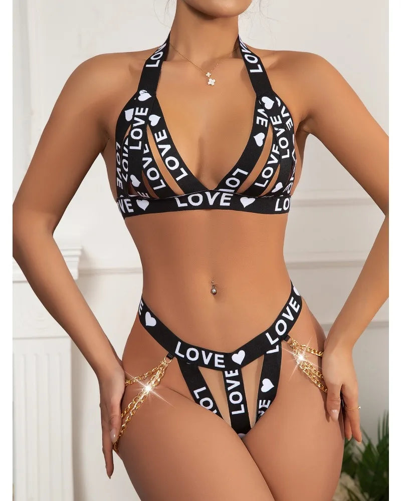 Black bikini with 'LOVE' and heart patterns on a white background