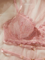 Pink bra with lace details on a soft pink background