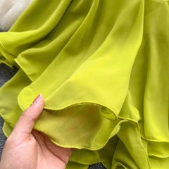 Close-up of a hand holding green fabric